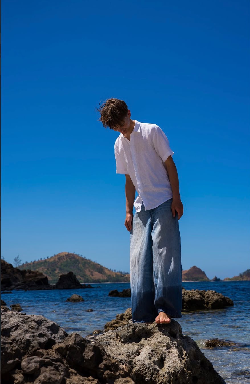 Teo Ladrière photographed on a coastal rock formation during a campaign shoot